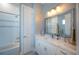 Bright bathroom featuring a vanity with marble countertop, modern lighting, and a shower/tub combo at 20256 Gulf Blvd, Indian Shores, FL 33785