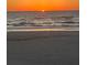 The sun sets over the ocean horizon on a beach with waves gently crashing on the sandy shore at 20256 Gulf Blvd, Indian Shores, FL 33785