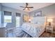 Comfortable bedroom with patterned bedding, a door to the outside, and stylish, ocean-inspired decor at 20256 Gulf Blvd, Indian Shores, FL 33785