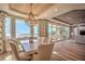 Elegant dining room featuring a stunning chandelier and breathtaking ocean views through large windows at 20256 Gulf Blvd, Indian Shores, FL 33785