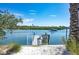Beautiful private boat dock with a boat cruising by, showcasing waterfront lifestyle at 20256 Gulf Blvd, Indian Shores, FL 33785