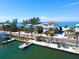 Beachfront home with stunning architecture, mature palm trees and private dock near a road at 20256 Gulf Blvd, Indian Shores, FL 33785