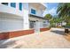 Charming home with a gated entrance and a well-manicured brick and paver walkway at 20256 Gulf Blvd, Indian Shores, FL 33785