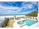 Inviting backyard oasis featuring a private pool, spa, lounge chairs and coastal views at 20256 Gulf Blvd, Indian Shores, FL 33785
