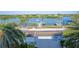 Scenic street view with palm trees and a glimpse of the waterway, offering a serene coastal lifestyle at 20256 Gulf Blvd, Indian Shores, FL 33785