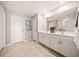 Bright bathroom with double vanity, white cabinets, framed mirrors, and decorative wall art at 21239 Dearborn Ave, Port Charlotte, FL 33981