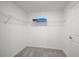 Walk-in closet with wire shelving and carpet flooring providing ample storage space at 23343 Van Buren Ave, Port Charlotte, FL 33981