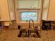 Kitchen sink features stainless steel basin, granite countertops, and natural lighting from the window at 3012 W Leroy St, Tampa, FL 33607