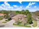 An aerial view shows this home with mature landscaping and a three-car garage in a well-kept neighborhood at 3185 Burberry St, Tarpon Springs, FL 34688