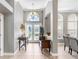 Bright foyer featuring high ceilings, arched doorways, decorative lighting, and a custom entry door at 3185 Burberry St, Tarpon Springs, FL 34688