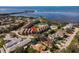 Wonderful aerial view of a condo community with pool, lush landscaping, and gorgeous waterfront views at 351 Windrush Loop, Tarpon Springs, FL 34689