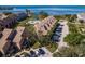 Aerial view of condo complex with private parking, community pool, and lush green spaces at 351 Windrush Loop, Tarpon Springs, FL 34689