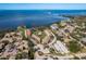 Expansive aerial shot of waterfront condo complex with a resort-style pool and lush landscaping at 351 Windrush Loop, Tarpon Springs, FL 34689
