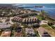 Sweeping aerial shot capturing a waterfront condo community with pool and surrounding homes at 351 Windrush Loop, Tarpon Springs, FL 34689