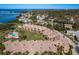 A high-angle aerial view of the condo complex with waterfront views and a lush green space at 351 Windrush Loop, Tarpon Springs, FL 34689