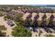 Aerial view of condo complex featuring convenient guest parking and a meticulously maintained landscape at 351 Windrush Loop, Tarpon Springs, FL 34689