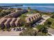 Overhead shot of condo complex with pool, parking, surrounding trees, and amazing water views at 351 Windrush Loop, Tarpon Springs, FL 34689