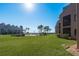 View of the grassy backyard overlooking the ocean at 351 Windrush Loop, Tarpon Springs, FL 34689