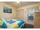 Cozy bedroom with colorful quilt, window, closet, and side table at 351 Windrush Loop, Tarpon Springs, FL 34689