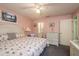 Light-filled bedroom with coastal decor, ceiling fan, and ensuite bathroom at 351 Windrush Loop, Tarpon Springs, FL 34689