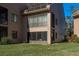 Exterior of a condo with a screened in porch or lanai and well manicured lawns at 351 Windrush Loop, Tarpon Springs, FL 34689