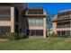 View of the condo exterior from the grass lawn at 351 Windrush Loop, Tarpon Springs, FL 34689