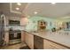 The well-lit updated kitchen features stainless appliances and granite countertops at 351 Windrush Loop, Tarpon Springs, FL 34689