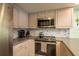 Up close view of the kitchen's stainless steel appliances and tile backsplash at 351 Windrush Loop, Tarpon Springs, FL 34689