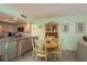 Kitchen dining area features a wooden table, chairs, and built-in cabinet at 351 Windrush Loop, Tarpon Springs, FL 34689