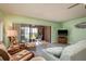 Comfortable living room with tile floors, plenty of seating, and sliding glass doors to screened-in lanai at 351 Windrush Loop, Tarpon Springs, FL 34689