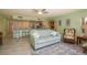 Inviting living room flows into kitchen and features tile floors, ceiling fan, and comfortable seating at 351 Windrush Loop, Tarpon Springs, FL 34689