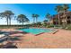 View of the community swimming pool and tanning chairs at 351 Windrush Loop, Tarpon Springs, FL 34689