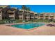 Community pool with ladder and tanning chairs at 351 Windrush Loop, Tarpon Springs, FL 34689