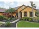 Welcoming exterior of single Gathering home with mature tropical landscaping and a sidewalk at 3637 Ballastone Dr, Land O Lakes, FL 34638