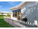 Back porch with a white picket fence and outdoor table and chairs at 3715 98Th N Ave # 3, Pinellas Park, FL 33782