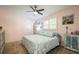 Serene bedroom features ceiling fan, natural light, and painted bedside cabinet at 3715 98Th N Ave # 3, Pinellas Park, FL 33782