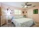 Cozy bedroom with ceiling fan, shuttered windows, and decorative wall art at 3715 98Th N Ave # 3, Pinellas Park, FL 33782