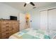 Comfortable bedroom with a dresser, closet, and a quilt bed featuring a beach-themed design at 3715 98Th N Ave # 3, Pinellas Park, FL 33782
