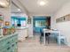 Cozy dining area with bright blue accent wall, new flooring, and lots of light from the Florida room at 3715 98Th N Ave # 3, Pinellas Park, FL 33782