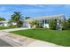 Charming single-story home with a well-maintained lawn, plants, and shrubs at 3715 98Th N Ave # 3, Pinellas Park, FL 33782