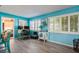 Bright office with gray wood floors, white shutters, and a whimsical painted storage cabinet at 3715 98Th N Ave # 3, Pinellas Park, FL 33782