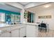 Bright kitchen with ample countertop space, updated cabinets, and an open view of the Florida room at 3715 98Th N Ave # 3, Pinellas Park, FL 33782