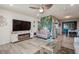 Relaxing living room featuring a cozy electric fireplace, hardwood floors, and ceiling fan at 3715 98Th N Ave # 3, Pinellas Park, FL 33782