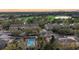 Aerial view showcasing the community, golf course, nearby lake, and city skyline at sunset at 39 Pelican Pl, Belleair, FL 33756