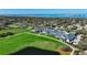 Aerial view highlighting the well-manicured golf course, clubhouse, and surrounding landscape at 39 Pelican Pl # 39, Belleair, FL 33756