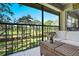 Outdoor balcony with seating area overlooking lush landscaping and golf course views at 39 Pelican Pl # 39, Belleair, FL 33756