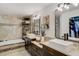 Bathroom featuring double sink vanity, soaking tub, and modern finishes at 39 Pelican Pl, Belleair, FL 33756