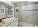 Modern bathroom featuring a glass-enclosed shower, a vessel sink on a vanity, and stylish tile accents at 39 Pelican Pl, Belleair, FL 33756
