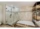 Bathroom showing glass enclosed shower, soaking tub, and built-in shelving at 39 Pelican Pl, Belleair, FL 33756