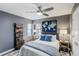 Bedroom with a ceiling fan, large art piece, and built-in shelving and storage at 39 Pelican Pl, Belleair, FL 33756